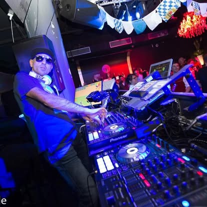 Jeff Kuzz mixing behind a club DJ setup